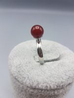 A solitaire ring of red carnelian with a silver hoop.