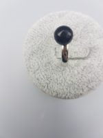 A BLACK ONYX SOLITAIRE RING with a black stone on top.
