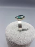 A DARK GREEN SWAROVSKI RING with a green tourmaline stone.