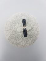 A STEEL RING WITH GLITTER with a diamond in the center.
