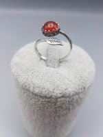 A RED CARNELIAN RING WITH LEAF with a red coral stone.