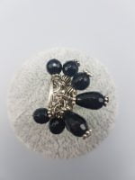 RING WITH BLACK ONYX CHARMS.