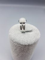 A WHITE JADE RING with a white stone on it.