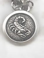 A MEN'S BRACELET PENDANT WITH TIGER'S EYE AND ROCK CRYSTAL WITH SCORPION PENDANT.