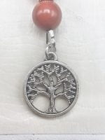 A necklace with a TREE OF LIFE KEYCHAIN and seven chakra colors on it.