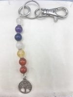 A KEYCHAIN WITH TREE OF LIFE AND SEVEN CHAKRA COLORS with the charm of the tree of life.