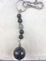 A KEYRING WITH BLACK ONYX with black and silver bead.