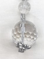 A KEYCHAIN WITH ROCK CRYSTAL OR HYALINE QUARTZ hanging from a silver chain.