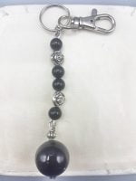 A KEYRING WITH BLACK ONYX with black and silver bead.