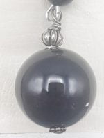 A KEYCHAIN WITH BLACK ONYX hanging from a silver chain.