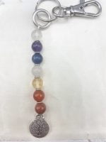 A KEYCHAIN WITH TREE OF LIFE AND SEVEN CHAKRA COLORS with the tree of life pendant.
