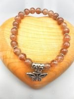 A SUNSTONE BRACELET WITH BUTTERFLY PENDANT with butterfly pendant.