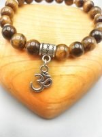 An 8mm tiger's eye bracelet with an OM pendant.