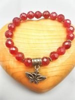 A RUBY JADE BRACELET with a PENDANT BUTTERFLY.
