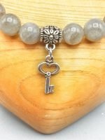 UN BRACCIALE DI LABRADORITE CON CIONDOLO CHIAVE con ciondolo chiave in argento.