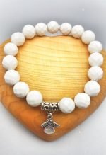 An 8MM WHITE AGATE BRACELET WITH ANGEL PENDANT with angel charm.