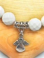 An 8mm white agate bracelet with angel pendant.