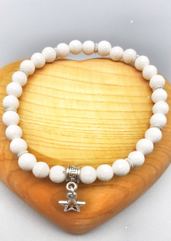 A 6MM WHITE AGATE BRACELET WITH STAR PENDANT with star charm.