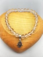 A 6MM ROCK CRYSTAL BRACELET WITH HAND OF FATIMA PENDANT with hamsa pendant in sterling silver.