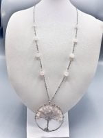 A ROSE QUARTZ TREE OF LIFE NECKLACE with a rose quartz tree.