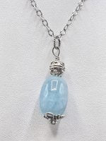 A large LARGE BARREL AQUAMARINE PENDANT on a silver chain.