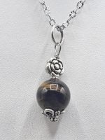 SMALL ROUND TIGER'S EYES PENDANT pendant on silver chain.