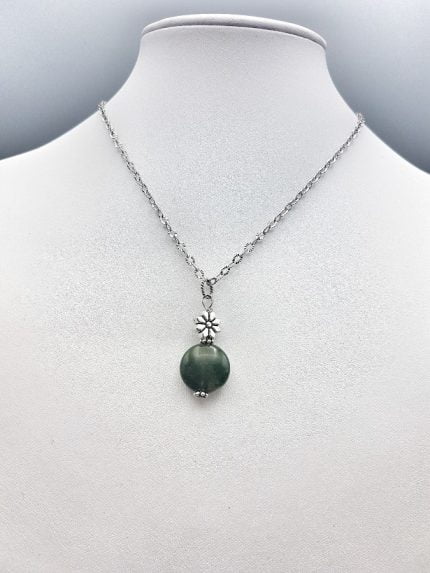 A flat musky agate pendant with a silver chain.