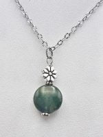 A flat musky agate pendant on a silver chain.