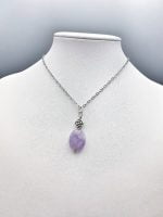 A purple OVAL AMETHYST PENDANT.