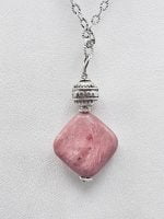 The RHODONITE PENDANT on a silver chain.