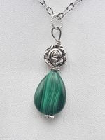 Malachite pendant of MALACHITE PENDANT on a silver chain.