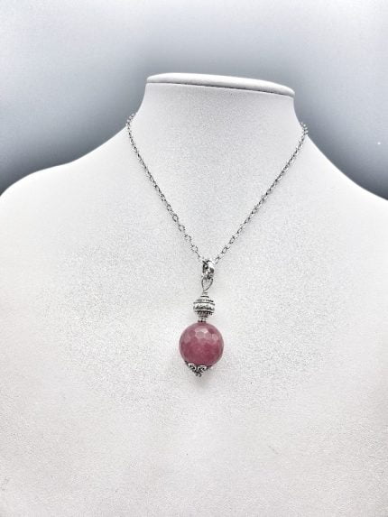 A necklace with a RUBY JADE PENDANT stone on it.