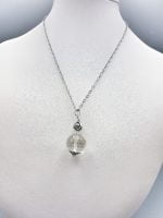 A rock crystal pendant with a clear crystal ball.