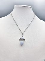 An angel chalcedony pendant on a mannequin.