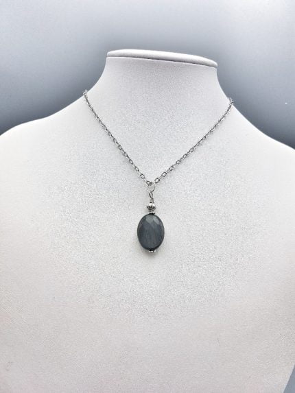 A necklace with a HAWKEYE PENDANT.