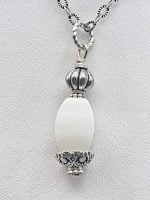 A white agate pendant from Bari lotto on a silver chain.