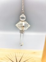 A necklace with a ROCK CRYSTAL PENDULUM on it.