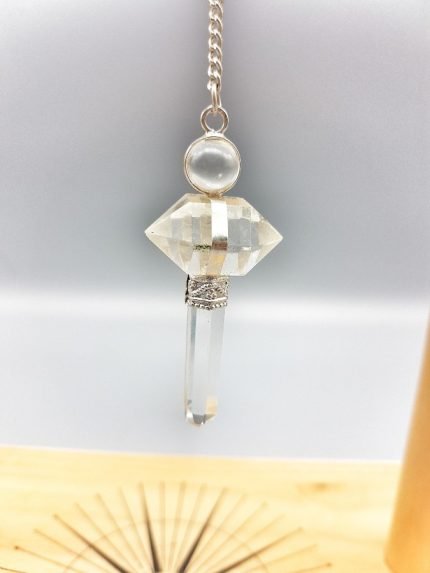 A necklace with a ROCK CRYSTAL PENDULUM on it.