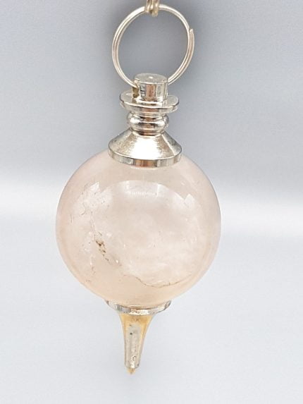 A spherical rose quartz pendulum hanging from a silver chain.
