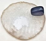 A piece of INCENSE BURNER SLICE OF WHITE AGATE with a blue stone on top.