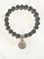 A black tourmaline bracelet with a silver charm.