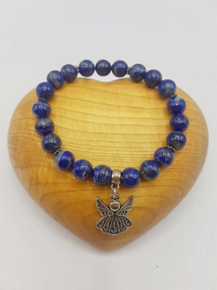 A LAPIS LAZULI BRACELET WITH ANGELIC PENDANT.