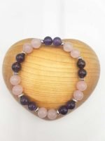 AN AMETHYST AND ROSE QUARTZ BRACELET DIAMETER 8 made with amethyst and rose quartz beads, measures 8 inches in diameter.