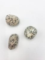 Three stones DALMANTINO TUMBLED on a white background.