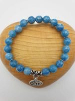AN ANGELITE BRACELET AND TREE OF LIFE with a silver pendant.