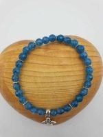 A blue Angelite bracelet with a silver pendant.