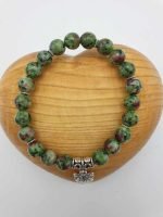 Un BRACCIALE DI ZOISITE RUBINO con perle di diaspro verde e un ciondolo d'argento.