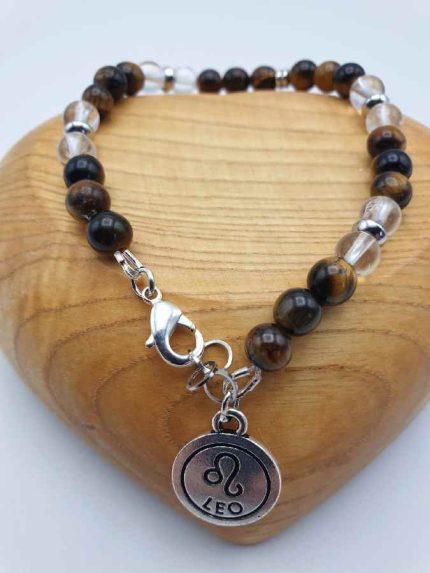 A MEN'S BRACELET WITH ROCK CRYSTAL, TIGER'S EYE AND LION PENDANT with tiger's eye pearl and lion pendant.