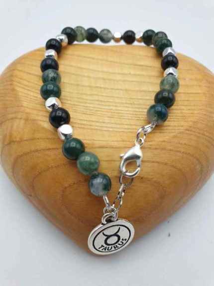 A Taurus pendant bracelet in green and silver hues.