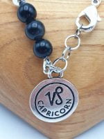 A bracelet with a zodiac sign and black onyx pearl with the Capricorn pendant MEN'S BRACELET WITH OBSIDIAN AND SMOKY QUARTZ WITH CAPRICORN PENDANT.